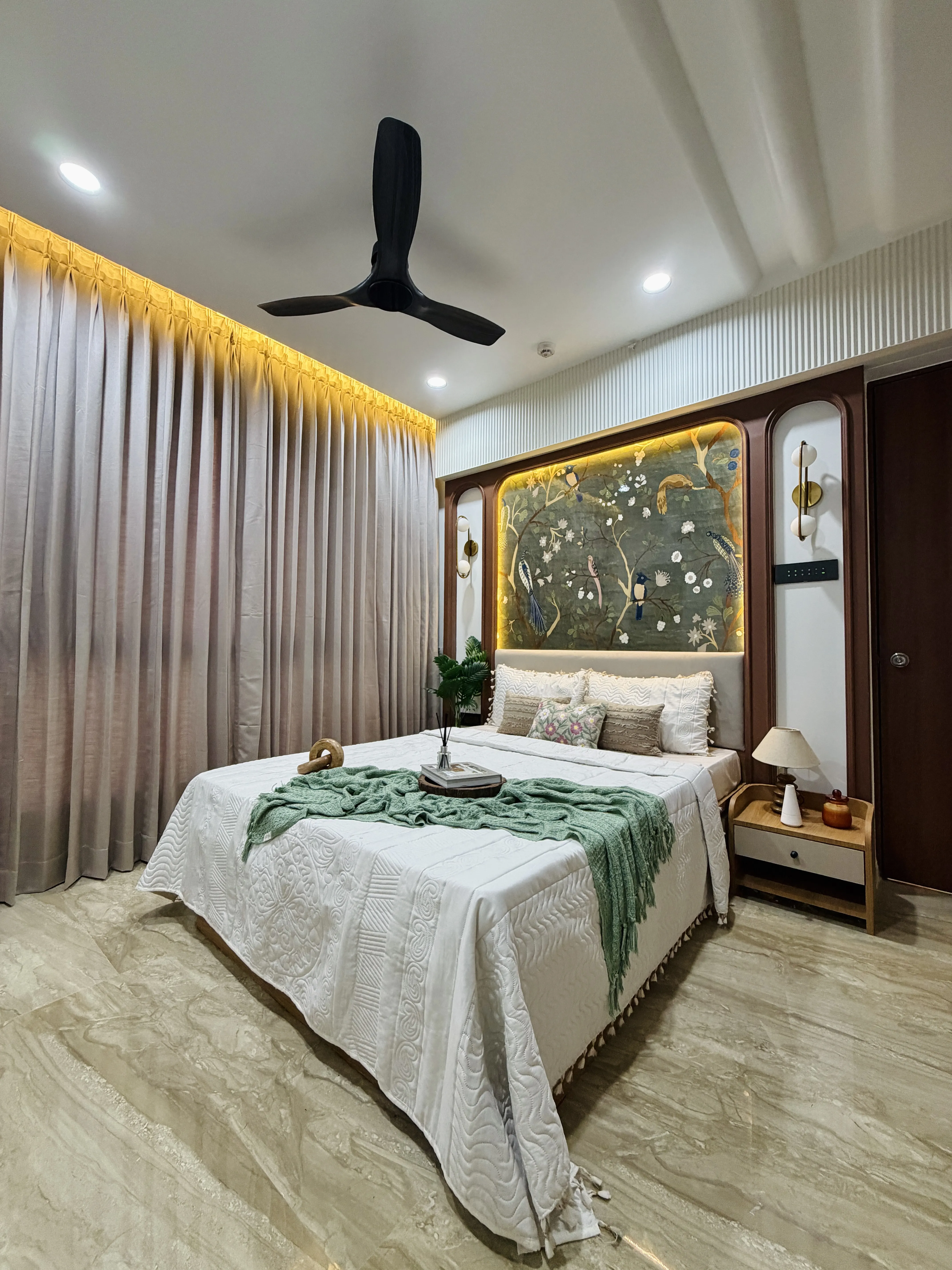 Second bedroom with textured accent wall and warm lighting